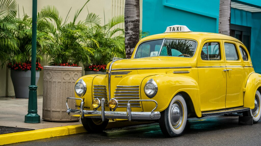 Photo of Yellow Taxi Parked Near Sidewalk